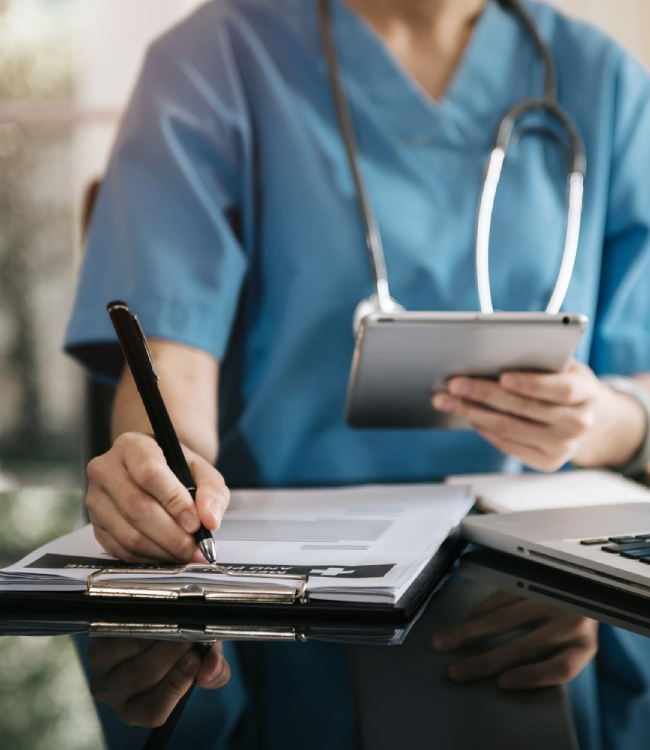 specjalista medyczny robi notatki przy laptopie